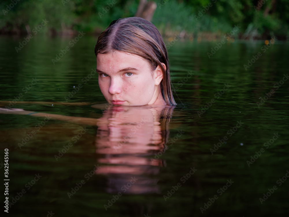 mermaid girl in the water among water lilies at sunset mermaid girl in the water among water lilies at sunset