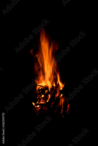 Bright firelight on a black background. Sparks and flames.