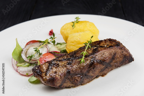 Grilled beef meat with pota...