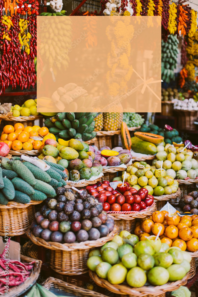 Funchal - Madeira, 09/20/2019. Fruit baskets at a farmers fair. Apples, bananas, peaches, kiwi and others. Vertical photo of a market with place for signature. 