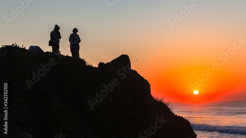 People Silhouetted Beach Rock Headland Watching Ocean Horizon Sunrise Sky Scenic Colors Of Nature Nature 