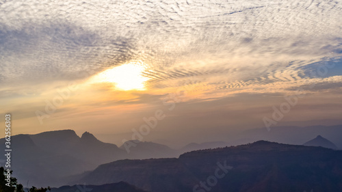 Spectacular silhouette view during sunset in Sahyadri mountain range on a winter evening from Sunset point at Matheran, Maharashtra, India.