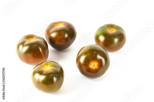 Group of black tomatoes isolated on white