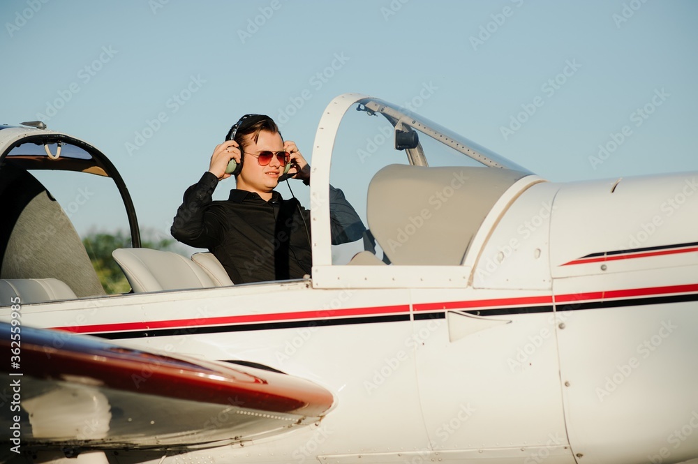 Young pilot is preparing for take off with private plane.