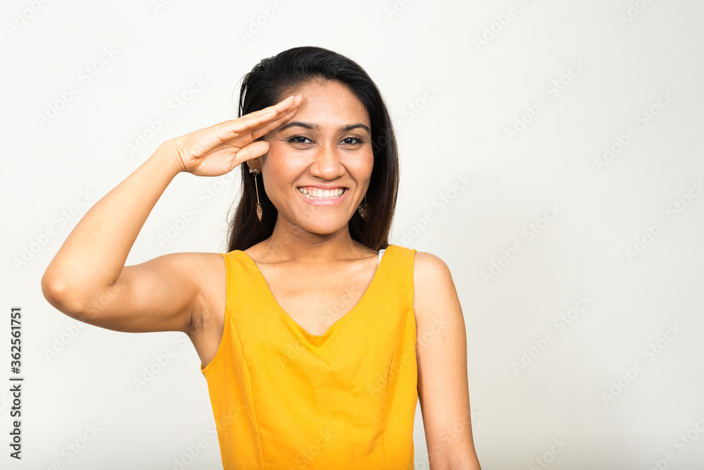 Portrait of happy Asian woman smiling and saluting Portrait of happy Asian woman smiling and saluting