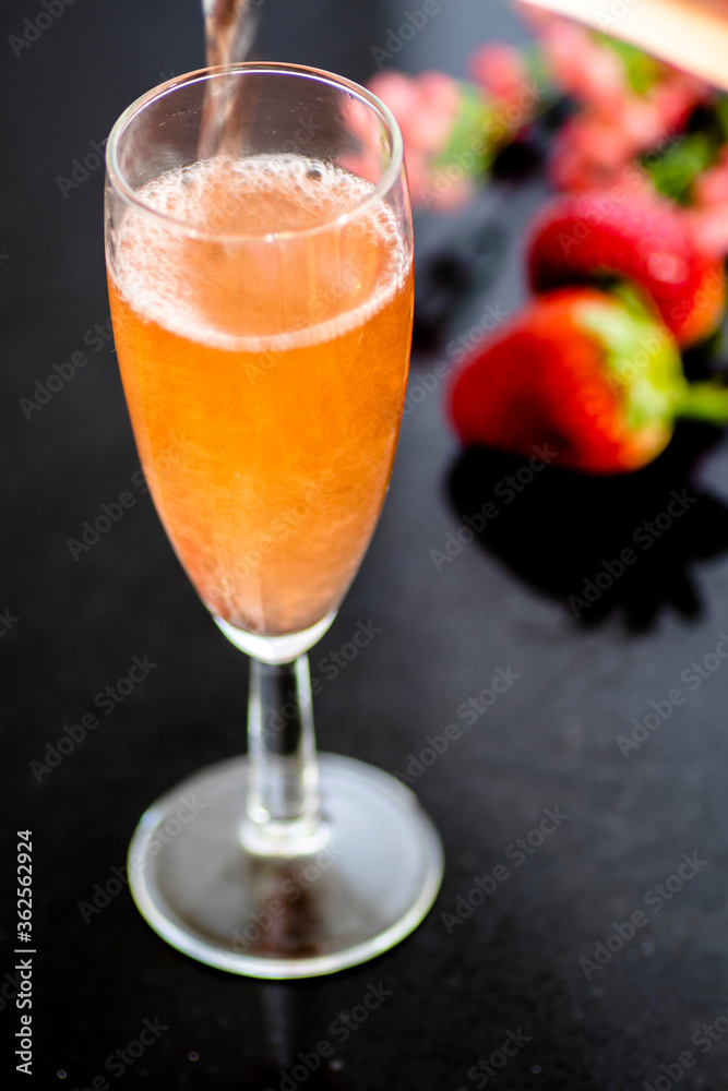 A glass of rose wine with strawberries A glass of rose wine with strawberries