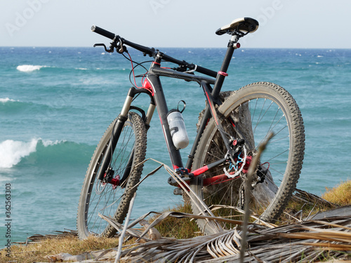 Mountain bike on ocean shore.. © Andrei