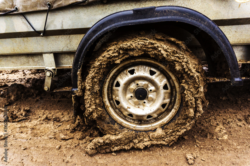 Dirty car wheel. Lack of paved roads. Close-up. Dirty car wheel. Lack of paved roads. Close-up.