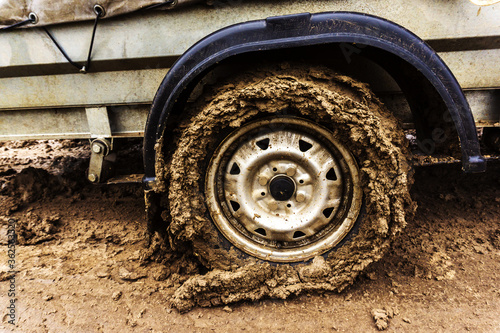Dirty car wheel. Lack of paved roads. Close-up. © Dmitry