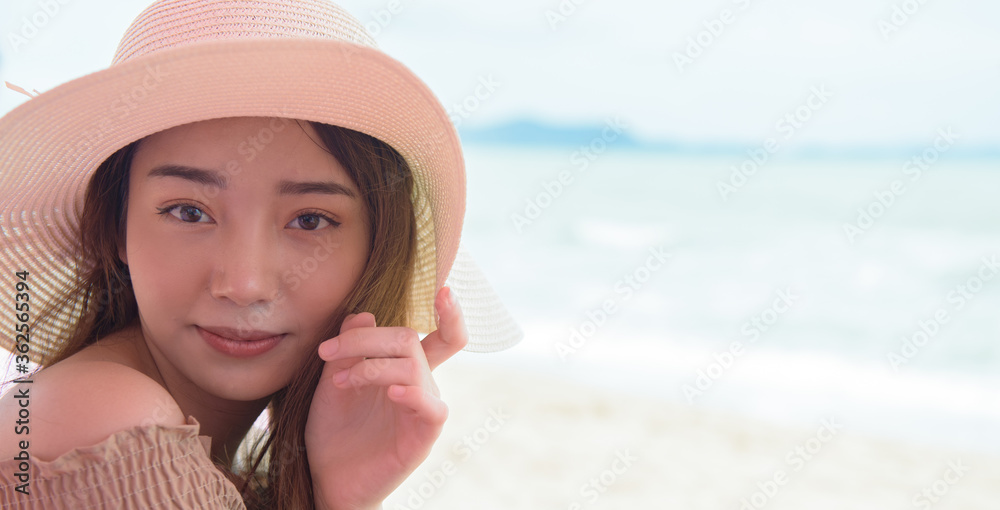 Smiling Asian girl on the beach.