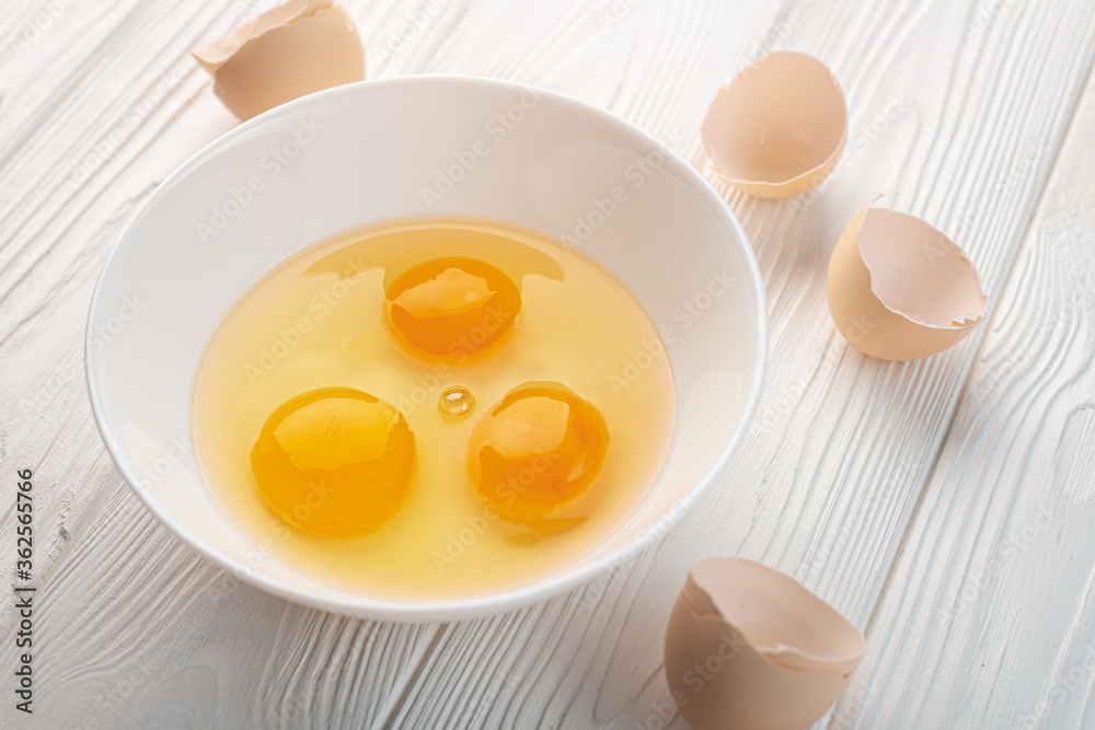Eggs chopped in a bowl and shell on a table Eggs chopped in a bowl and shell on a table