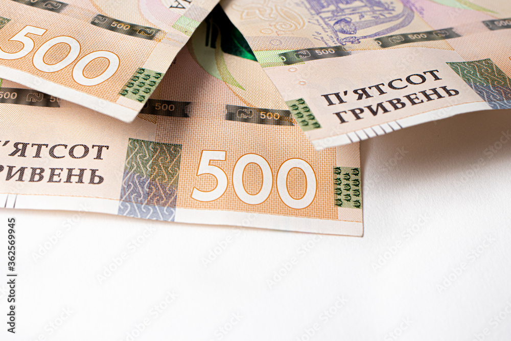 Five hundred Ukrainian hryvnia in an envelope on an orange background 3 Five hundred Ukrainian hryvnia in an envelope on an orange background 3