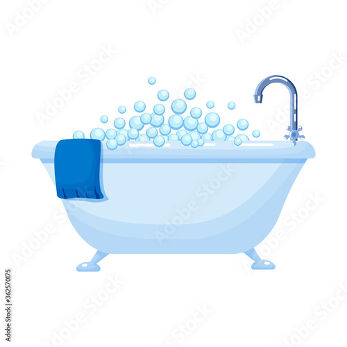 Bathtub full of soap foam bubbles with  blue towel