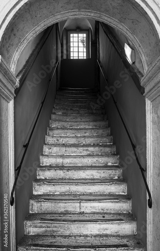 Black and white photo stairs inside medieval italian building