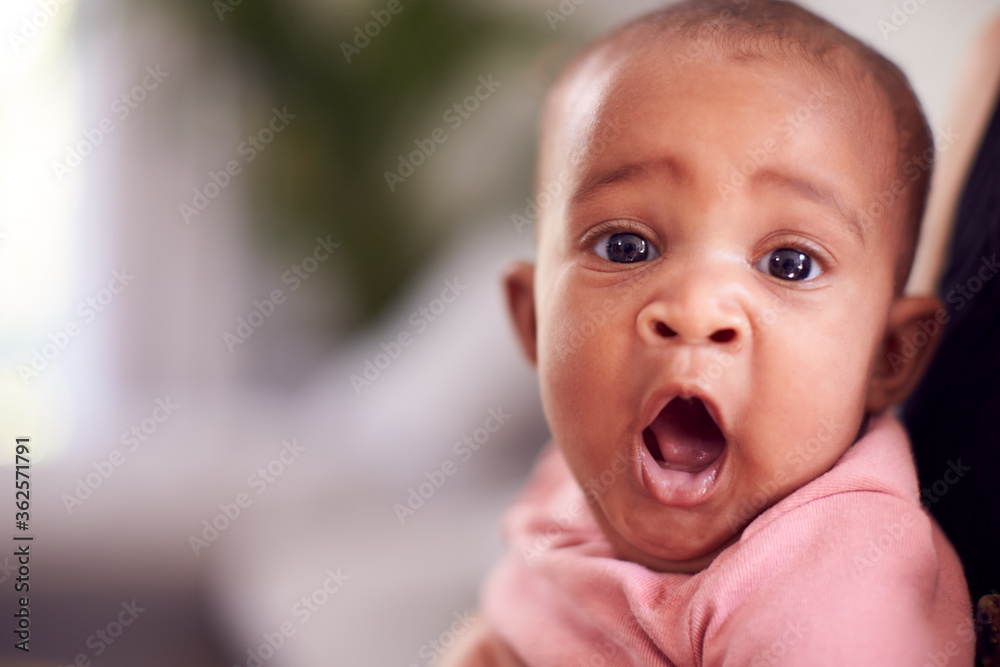 Portrait Of Smiling Baby Girl With Open Mouth In Sling Portrait Of Smiling Baby Girl With Open Mouth In Sling