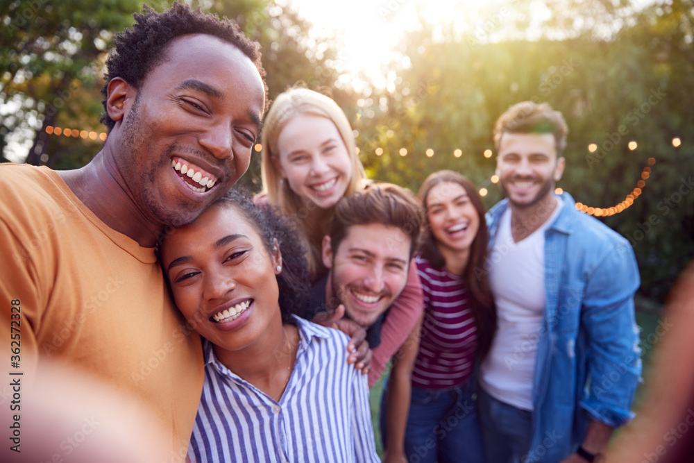 Group Of Multi-Cultural Friends Posing For Selfie As They Enjoy Outdoor Summer Garden Party