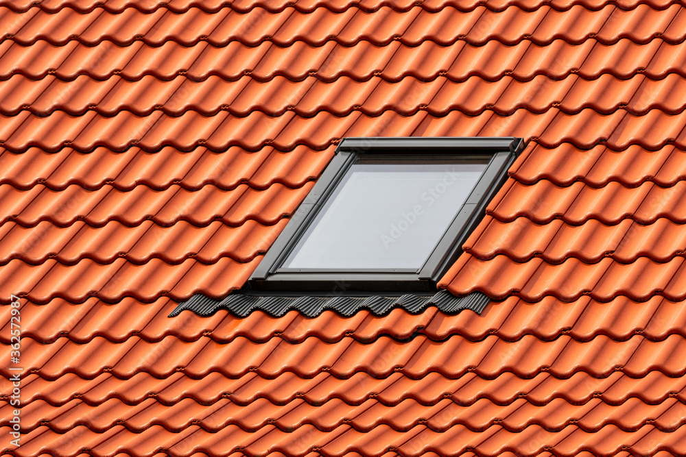 Skylight on red ceramic roof tiles Skylight on red ceramic roof tiles