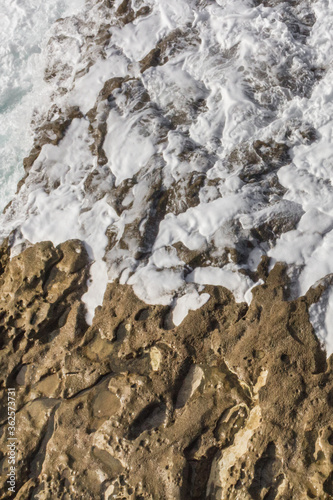 Wallpaper Mural Bay of Biscay. Raging force of nature. Waves lick stones and beat against rocks. Spanish coast. Salty sea air. Boulders and stones in the spray of sea waves. Seascape view from above. Frosty breeze.  Torontodigital.ca