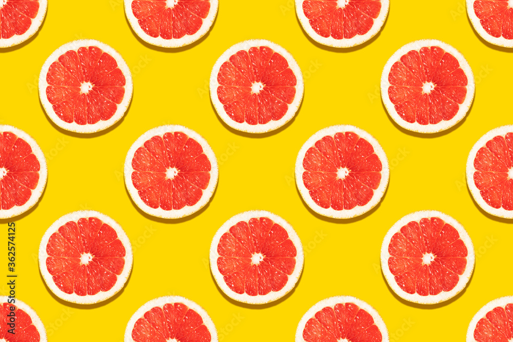 Seamless pattern with a slice of grapefruit on a yellow background. Drawing for decoration, packaging, banner. advertising. Seamless pattern with a slice of grapefruit on a yellow background. Drawing for decoration, packaging, banner. advertising.
