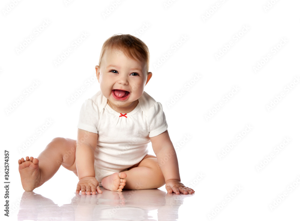 Seven month Infant child baby toddler sitting and happy looking laughing at the corner with text space isolated on a white Seven month Infant child baby toddler sitting and happy looking laughing at the corner with text space isolated on a white