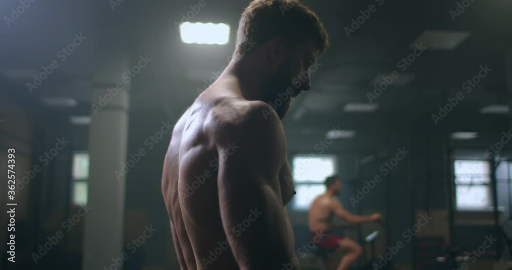 focused men in the gym are getting ready to start training. a professional athlete performs exercises in the gym. focus and purpose focused men in the gym are getting ready to start training. a professional athlete performs exercises in the gym. focus and purpose