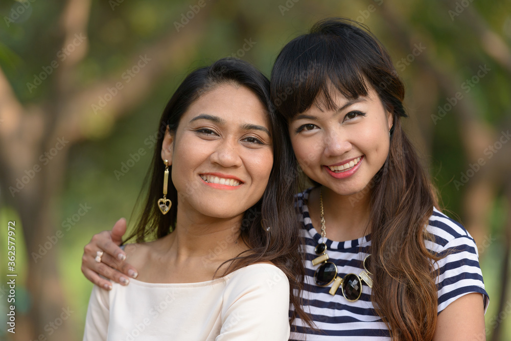 Portrait of two happy young Asian women together at the park Portrait of two happy young Asian women together at the park