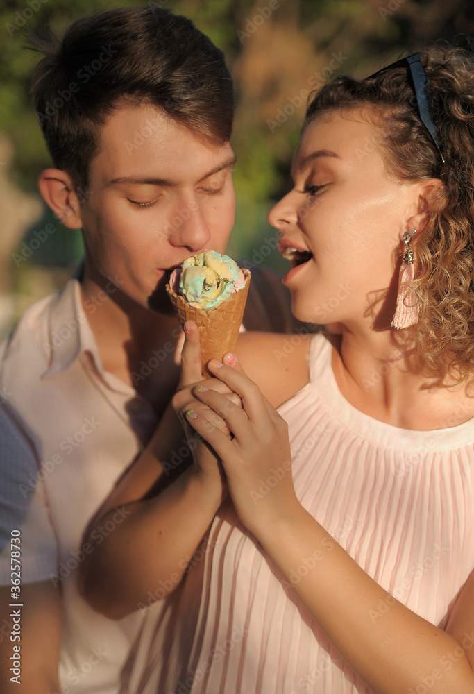 Happy couple has fun outdoors with ice cream. Happy couple has fun outdoors with ice cream.