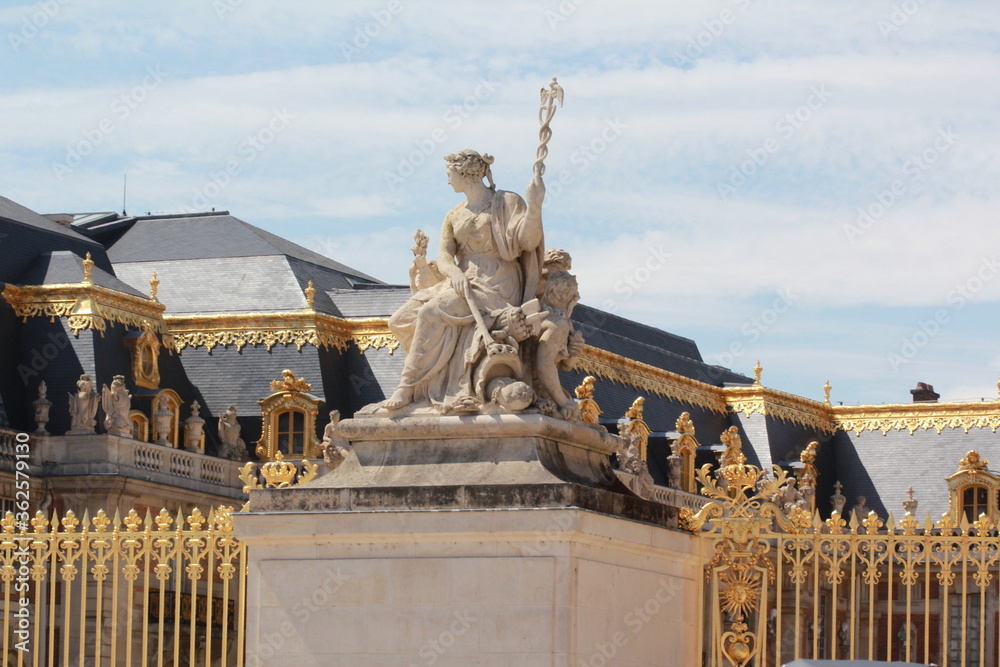 Sculpture near the golden gates of the Palace of Versailles, France