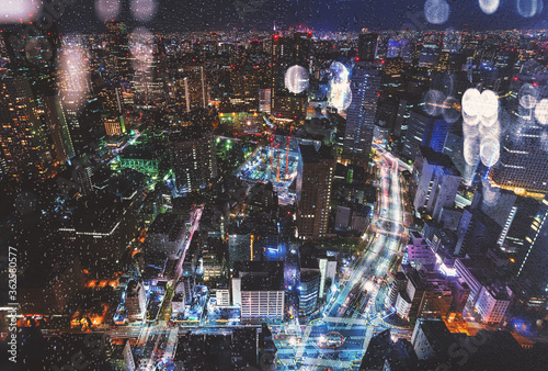 Wall Mural Skyscrapers illuminated in the rain at night in Tokyo, Japan