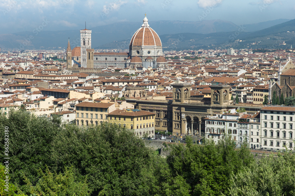 Panoramic view of the old city of Florence with buildings, houses and the Cattedrale di Santa Maria del Fiore (Cathedral of Saint Mary of the Flower) on a sunny day