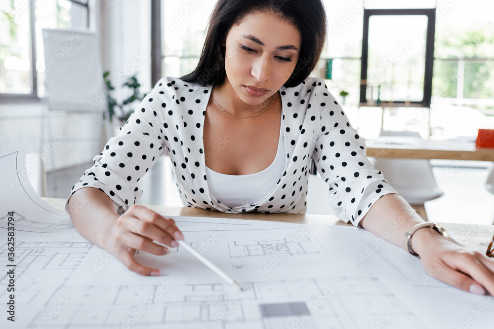selective focus of pretty businesswoman drawing blueprints in office selective focus of pretty businesswoman drawing blueprints in office