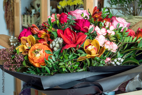 Close-up shot of a beautiful and stylish bouquet of fresh various flowers in floral design studio, flower shop.