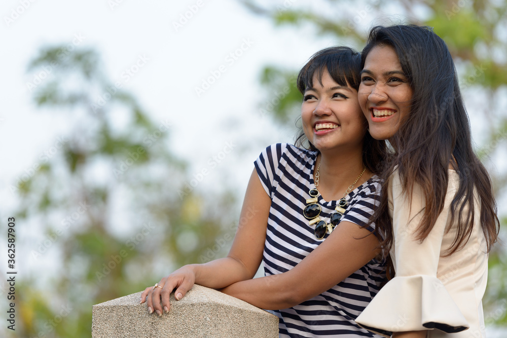 Portrait of two happy young Asian women together at the park Portrait of two happy young Asian women together at the park