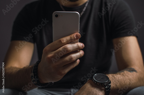 young man texting on mobile phone