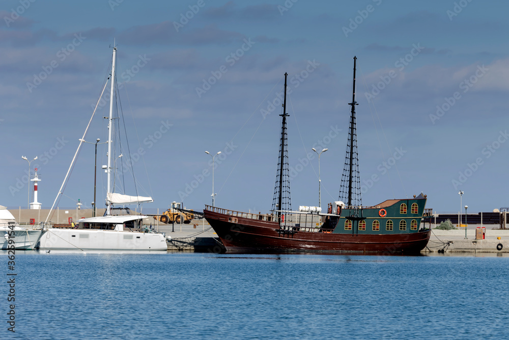 Obraz premium Tourist pirate ship approached the shore (island Crete, city Rethymno) on a sunny winter day (Greece)