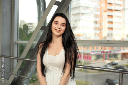 Portrait of a beautiful brunette in a light dress on the street in a pedestrian crossing on a summer day Free Download Portrait of a beautiful brunette in a light dress on the street in a pedestrian crossing on a summer day - GFXLoad