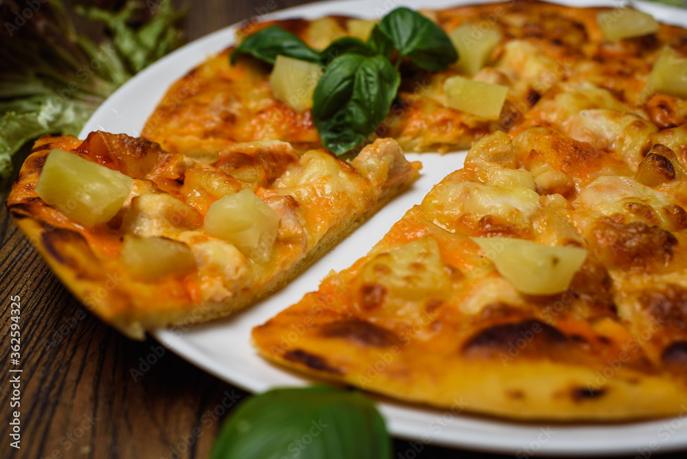 
pizza with meat and tomatoes under cheese