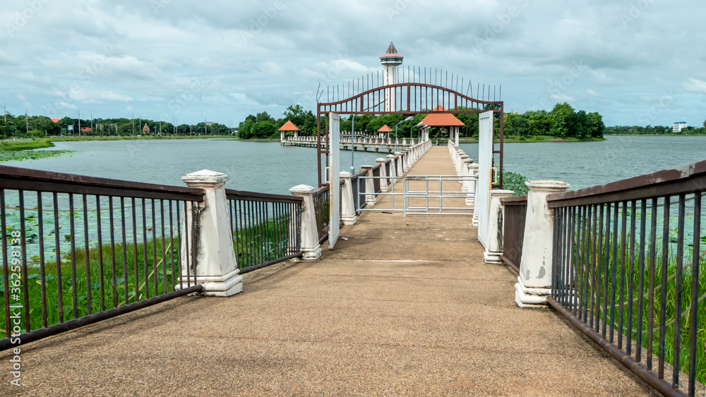 Walkway on the bridge over the pond in the park