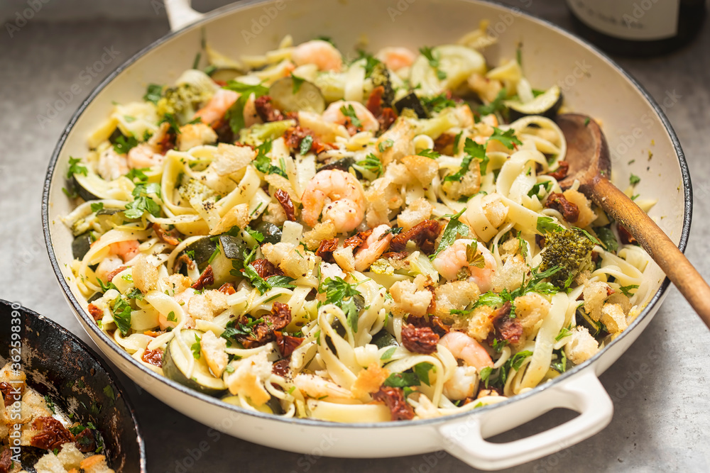 Tagliatelle pasta with broccoli, courgette, shrimps, white wine and sun dried tomatoes breadcrumbs