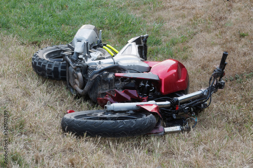 Motorcycle bike accident broken and wrecked moto on grass..