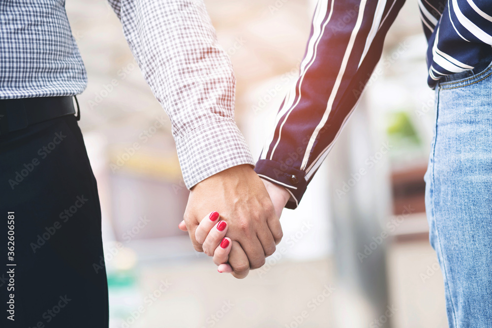 Fototapeta premium close up woman and man holding hands with a wedding ring, Happy couple love in the outdoor. concept lover valentine day.