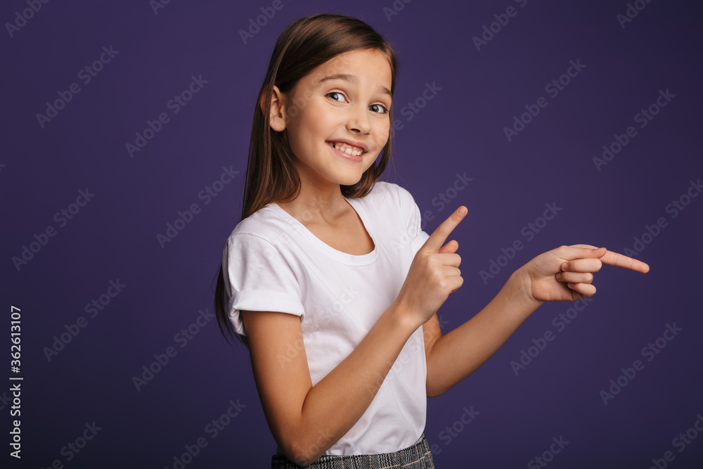 Photo of joyful attractive girl smiling and pointing fingers aside Photo of joyful attractive girl smiling and pointing fingers aside
