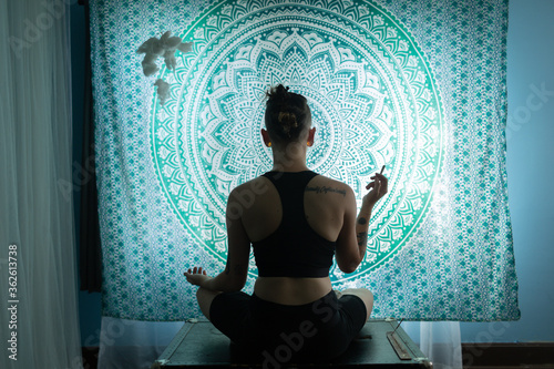 meditating in yoga pose smoking marijuana 