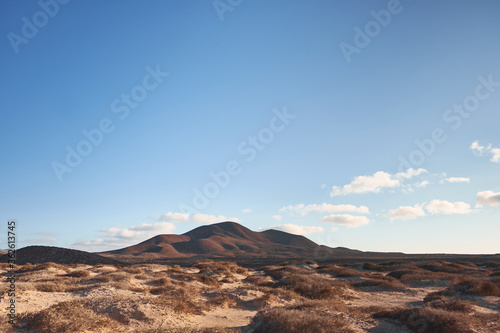 hill and cloud over blue sky