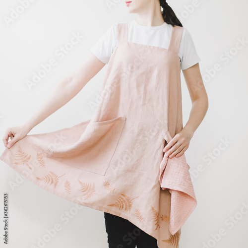 housewife in linen apron isolated on white background. Housekeeper woman in apron in the kitchen. Copy space for advertisement
