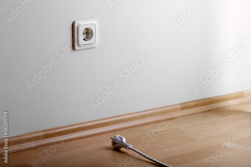 Problem to connect. White power socket on beige wall at low height from the floor and a short cable