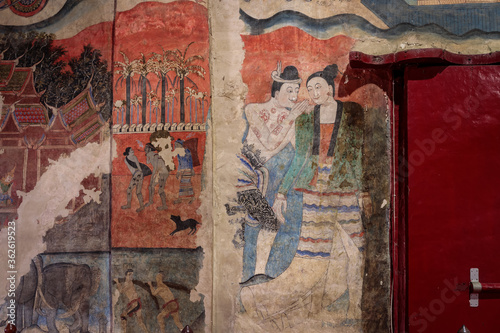Ancient wall fresco painting, love whispering, in ordinance chapel at Wat Phumin. Famous tourist attraction and destination. photo