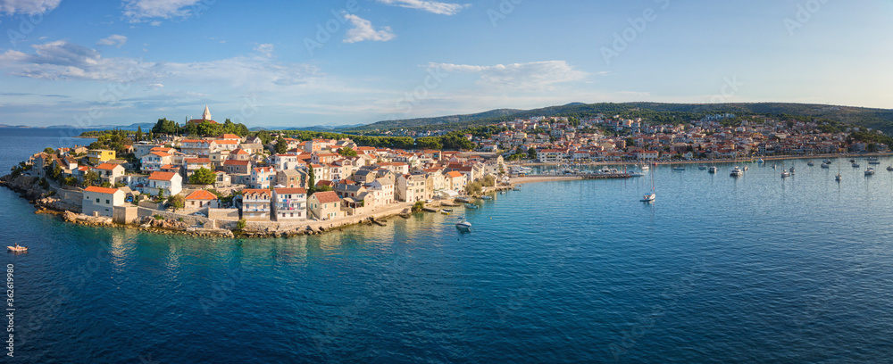 Aerial view of Primosten old town on the islet, amazing sunny landscape, Dalmatia, Croatia. Famous tourist resort on Adriatic sea coast, outdoor travel background