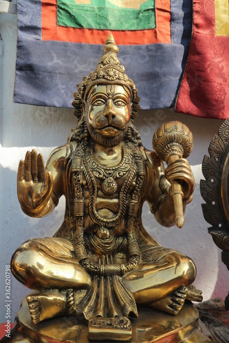 Bronze statuette - Hanuman sits in lotus pose with mace and blessing gesture.