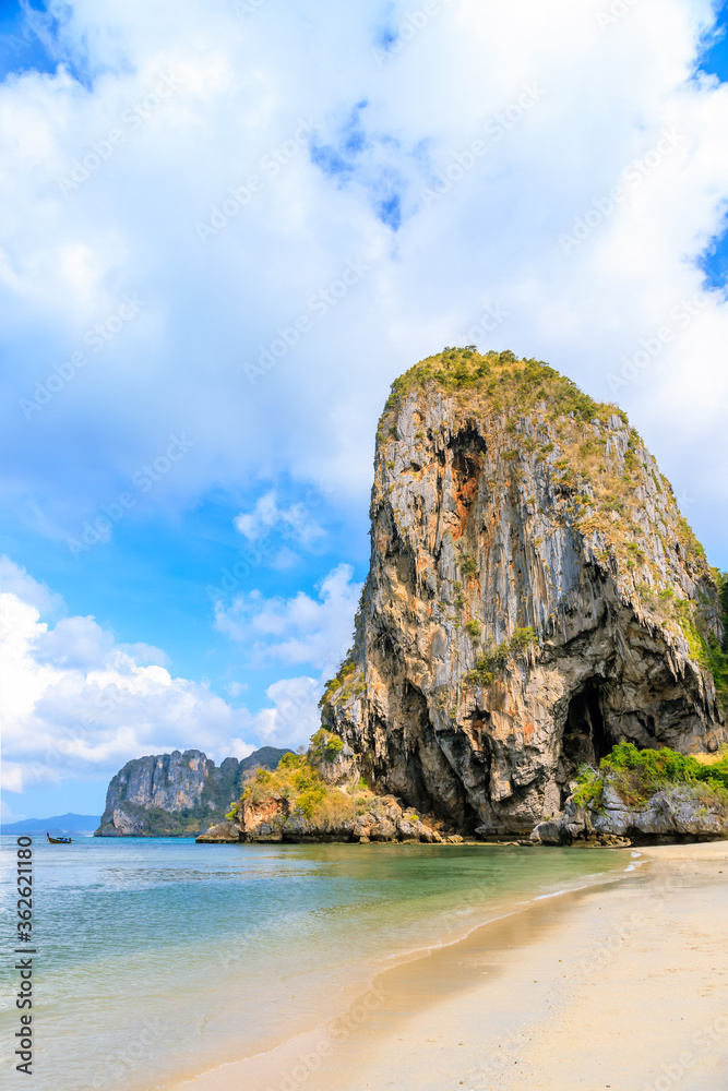 Turquoise crystal clear sea water with limestone cliff and mountain at Phra Nang Beach, Krabi, Thailand